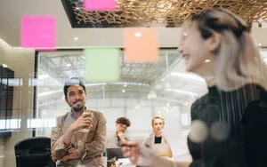 Team Scrum-style meeting using Post-it notes.