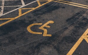 © Photographer: Jakub Pabis
Source: Unsplash A handicap parking space with a yellow wheelchair symbol