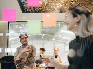 Team Scrum-style meeting using Post-it notes.