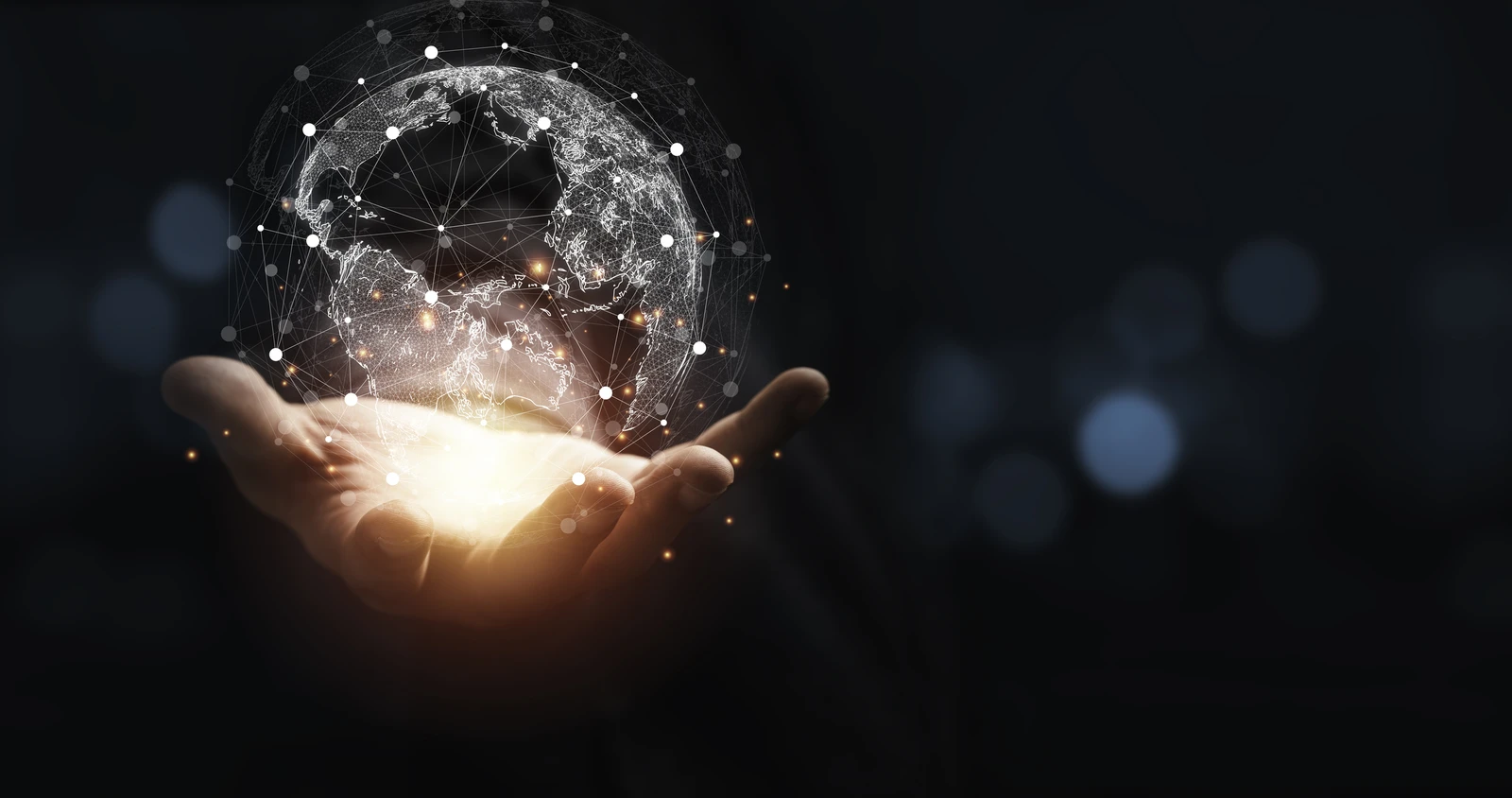 Hand holding a glowing virtual globe with network connections